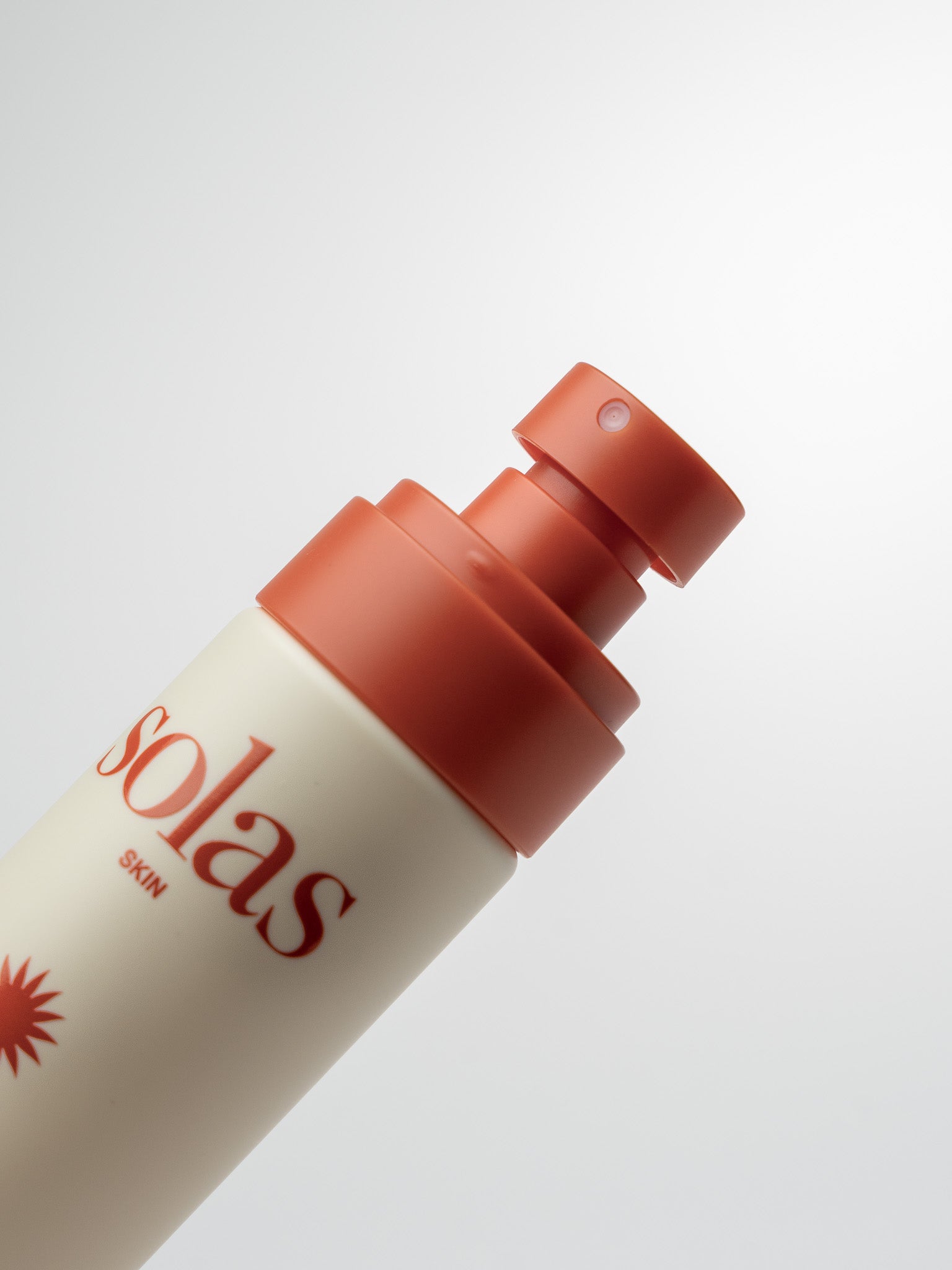 Solas Spritz bottle with red cap on a light grey background