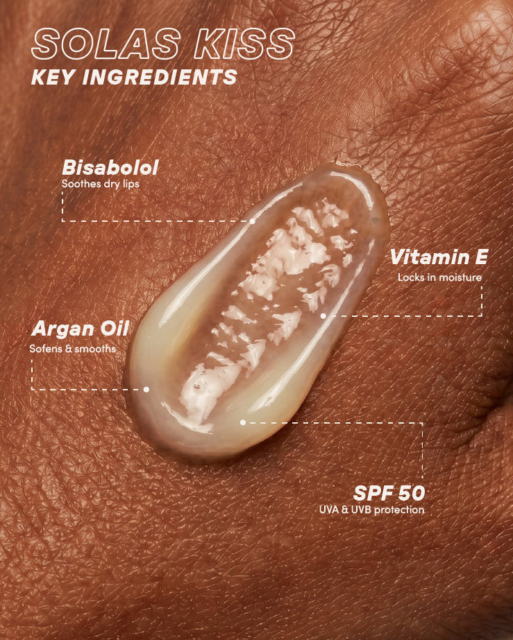 Lip balm with key ingredients labeled on a the back of someones hand.