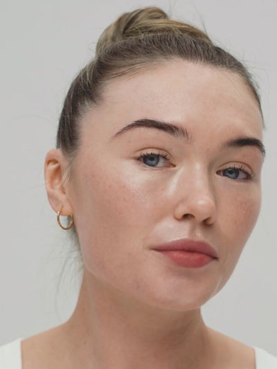 Woman applying Solas Sun cream to face